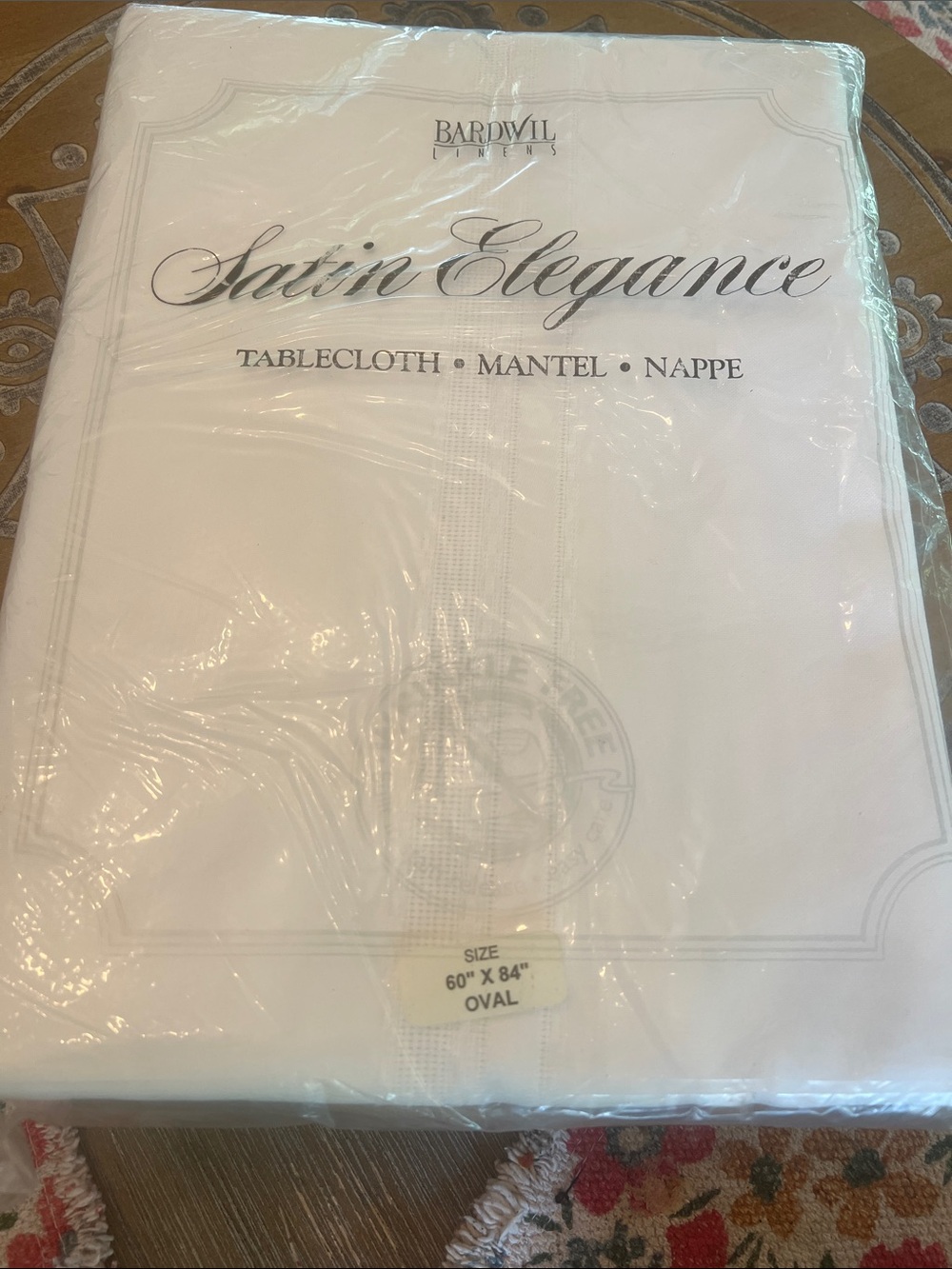 Satin Elegance White Oval Tablecloth by Bardwell. Off white simple cloth.